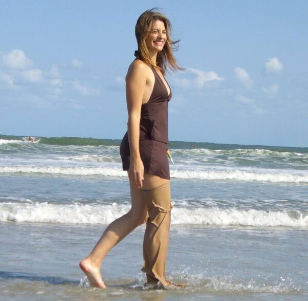 Woman walking on the beach and wearing DryPro Waterproof Prosthetic Leg Cover