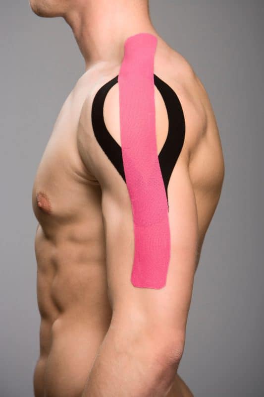 Athlete wearing k tape on his shoulder and arm.
