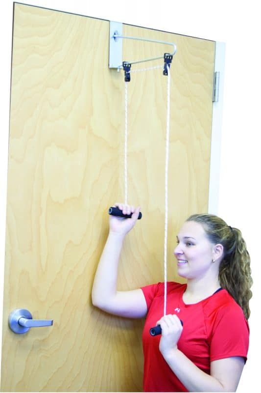 Woman doing shoulder range of motion exercises with the CanDo® Overdoor Shoulder Pulley