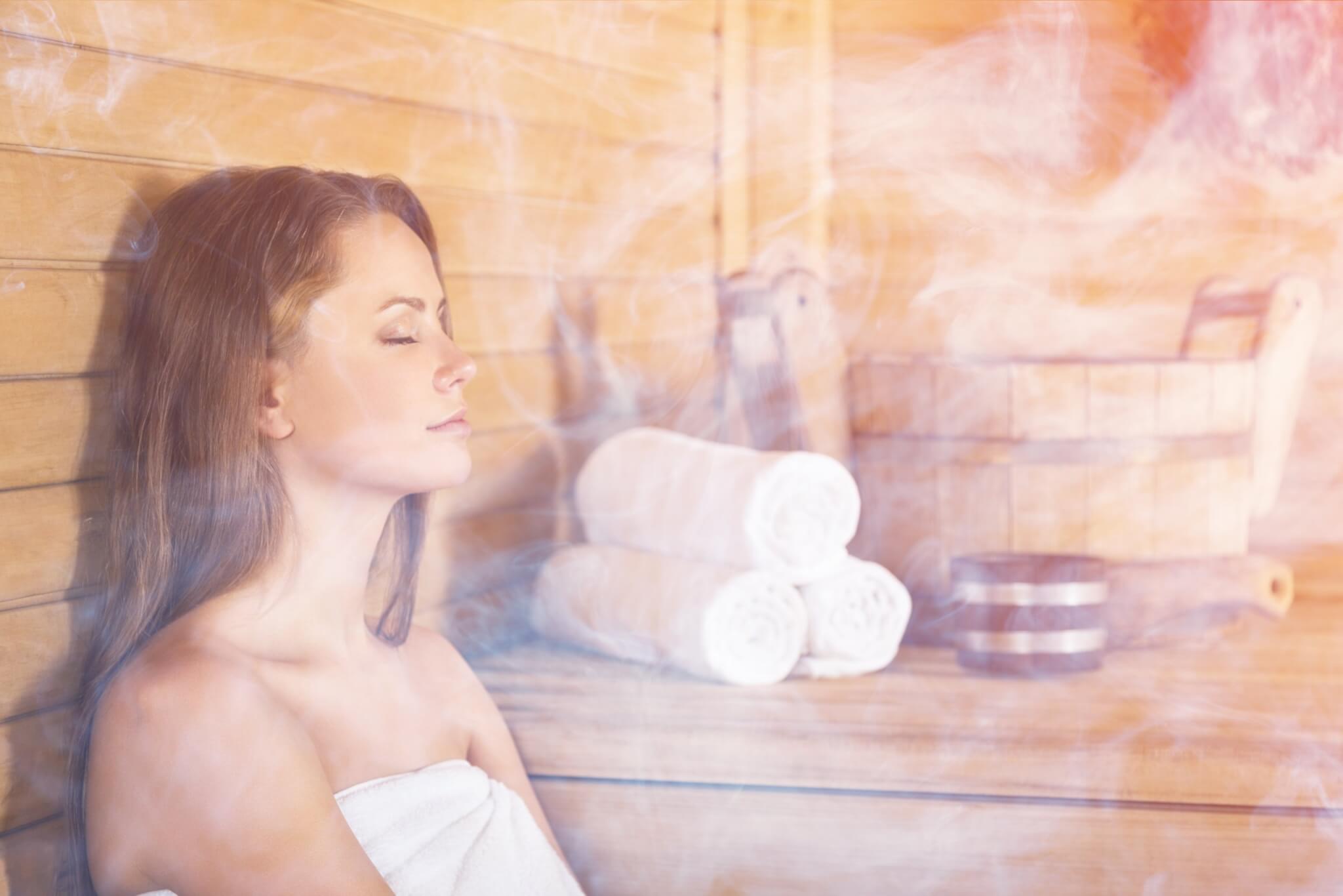 A woman enjoying a sauna - one of many forms of moist heat therapy.