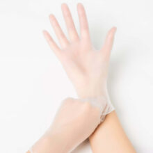 Image of a pair of hands wearing vinyl medical exam gloves. These tend to be the best medical exam glove when the budget is tight and disposable use is needed to control cross contamination risk.