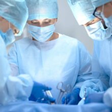 Surgeons wearing face masks in the operating room scaled