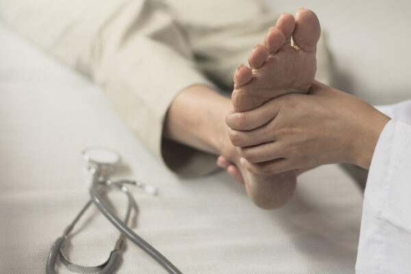Patient receiving treatment for pain under the heel